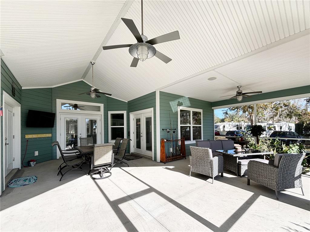 19151 Southeast 135th Court Dunnellon, FL 34431 - Photo 12 of 65 a living room with furniture a flat screen tv and a large window