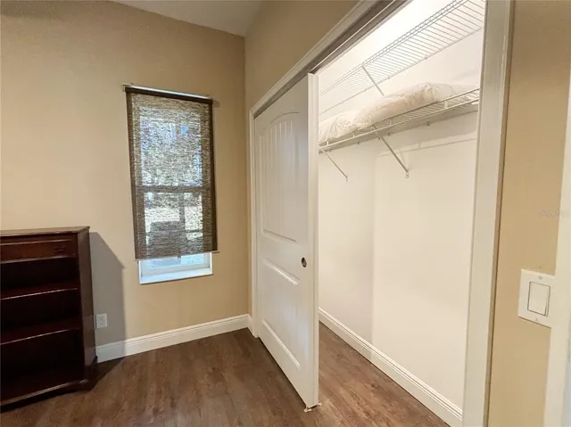 a large white kitchen with lots of counter space and stainless steel appliances