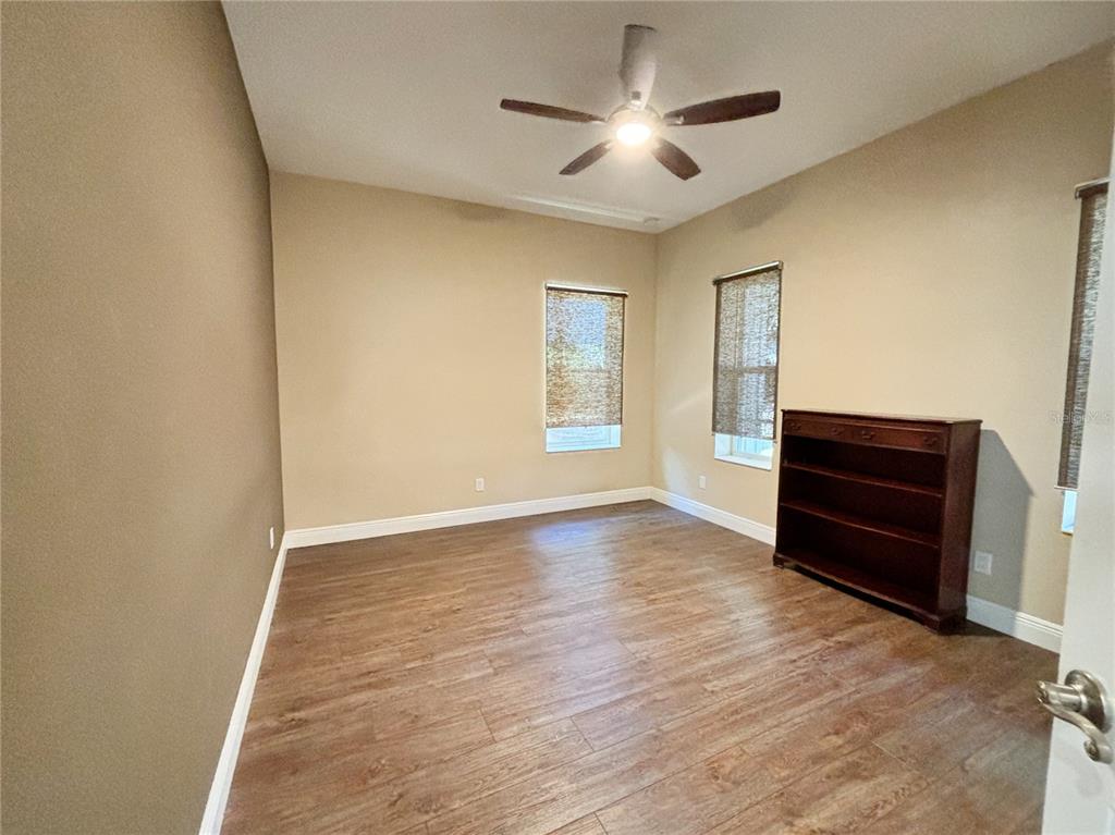 19151 Southeast 135th Court Dunnellon, FL 34431 - Photo 16 of 65 a view of empty room with wooden floor and fan