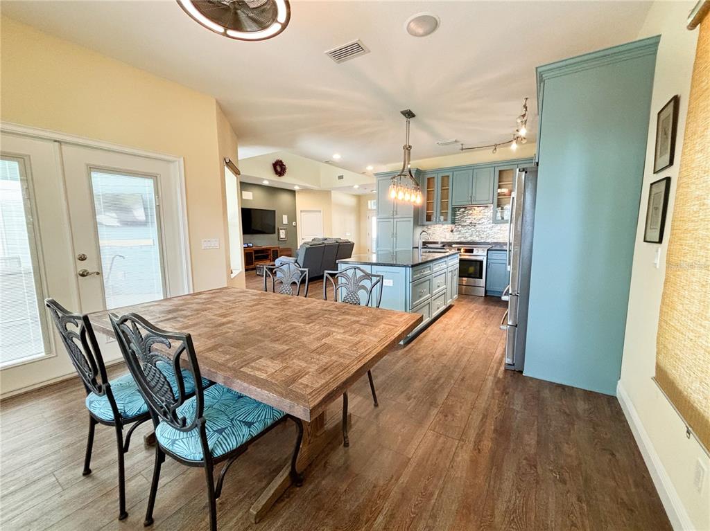 19151 Southeast 135th Court Dunnellon, FL 34431 - Photo 19 of 65 a dining hall with stainless steel appliances a dining table chairs with wooden floor