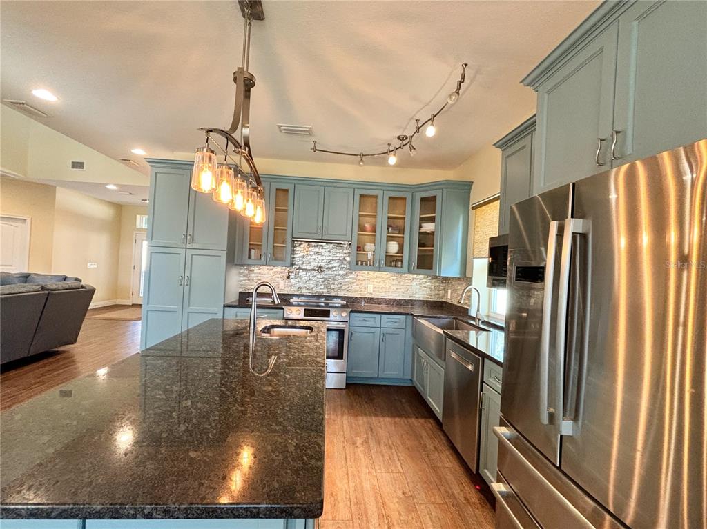 19151 Southeast 135th Court Dunnellon, FL 34431 - Photo 23 of 65 a kitchen with stainless steel appliances granite countertop a sink a stove and a refrigerator