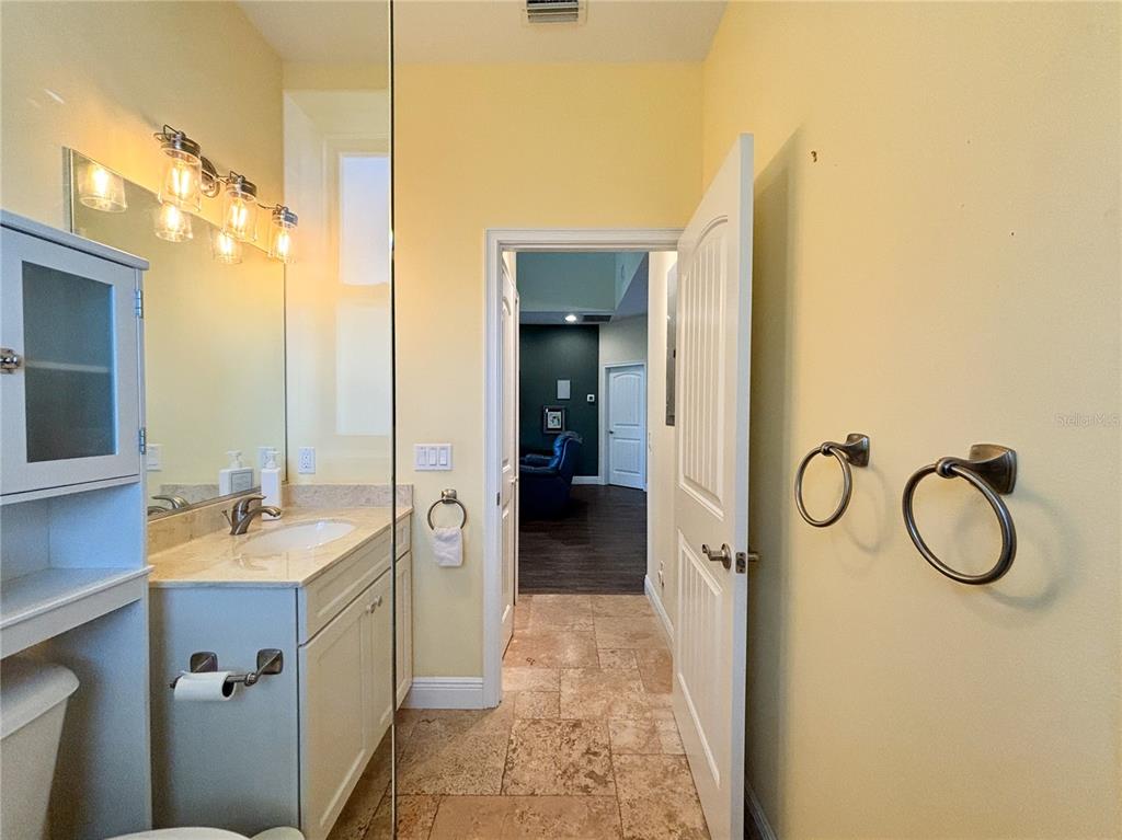 19151 Southeast 135th Court Dunnellon, FL 34431 - Photo 27 of 65 a bathroom with a granite countertop sink and a mirror