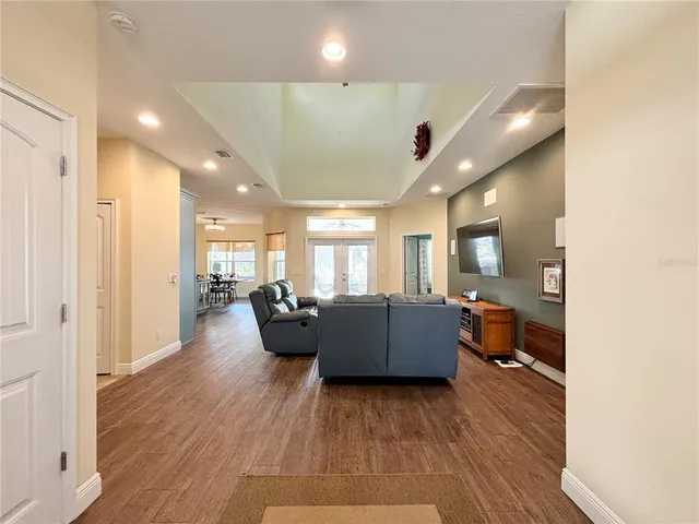 a bedroom with a bed lamps and a large window