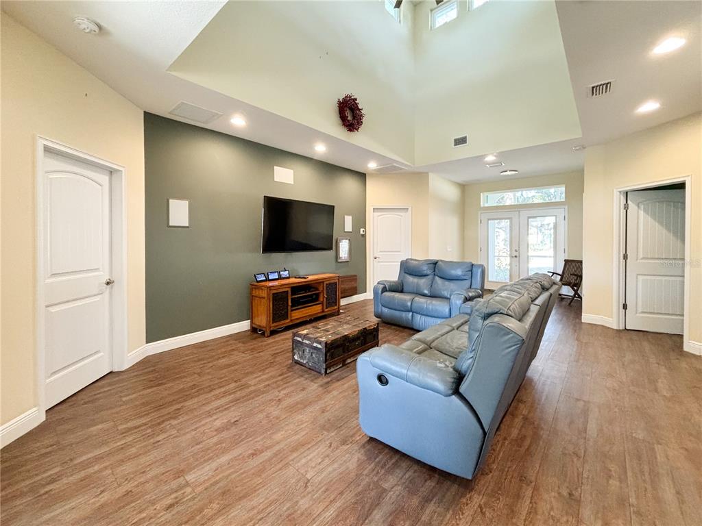 19151 Southeast 135th Court Dunnellon, FL 34431 - Photo 40 of 65 a living room with furniture and a flat screen tv