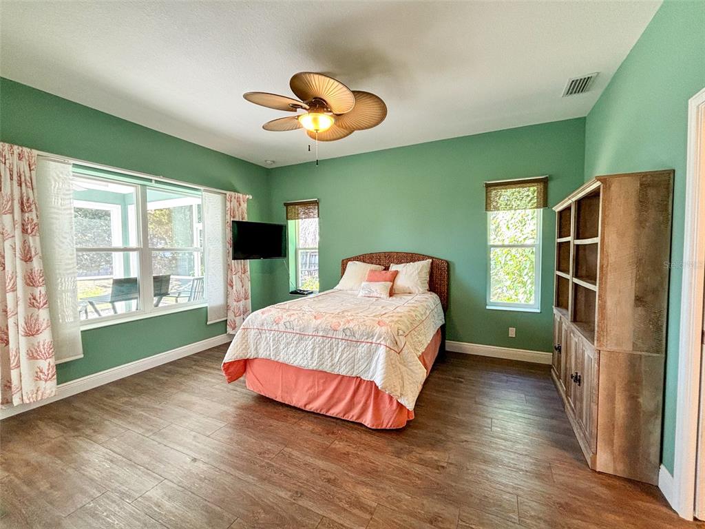 19151 Southeast 135th Court Dunnellon, FL 34431 - Photo 42 of 65 a bedroom with a bed lamps and a large window