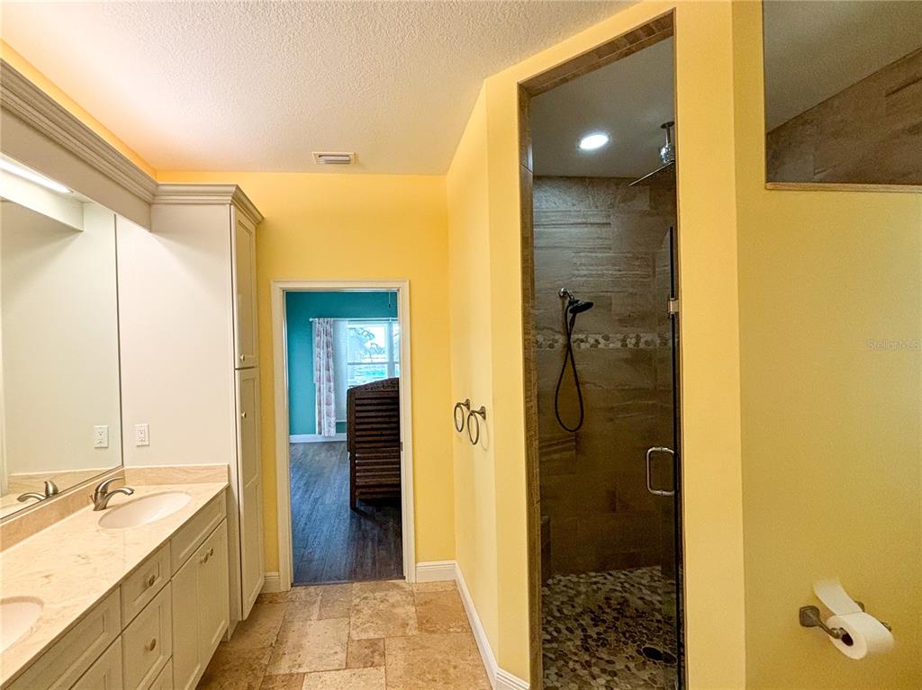19151 Southeast 135th Court Dunnellon, FL 34431 - Photo 48 of 65 a bathroom with a granite countertop shower mirror and a sink