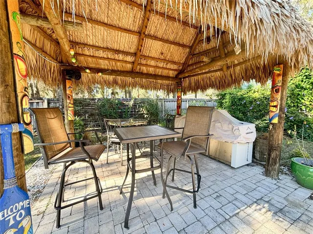 a view of a patio with table and chairs and potted plants