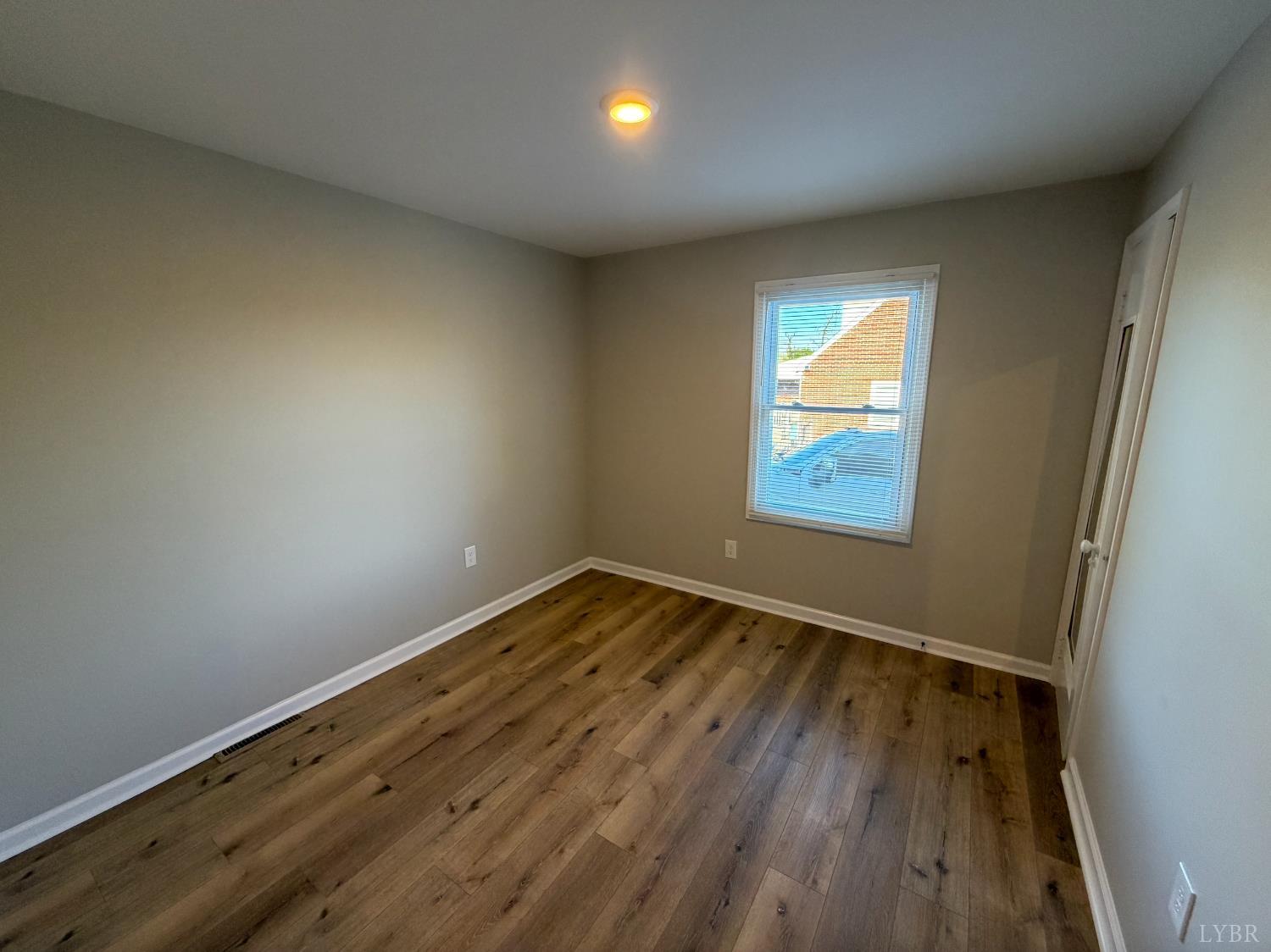 127 Campbell Street Madison Heights, VA 24572 - Photo 14 of 28 a view of empty room with wooden floor and fan