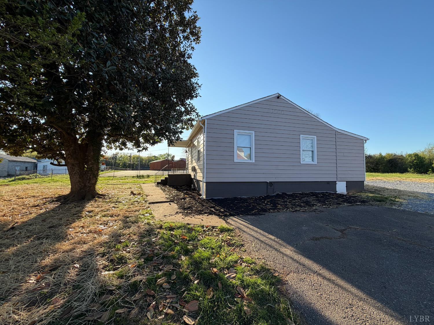 127 Campbell Street Madison Heights, VA 24572 - Photo 22 of 28 a backyard of a house with large trees and wooden fence