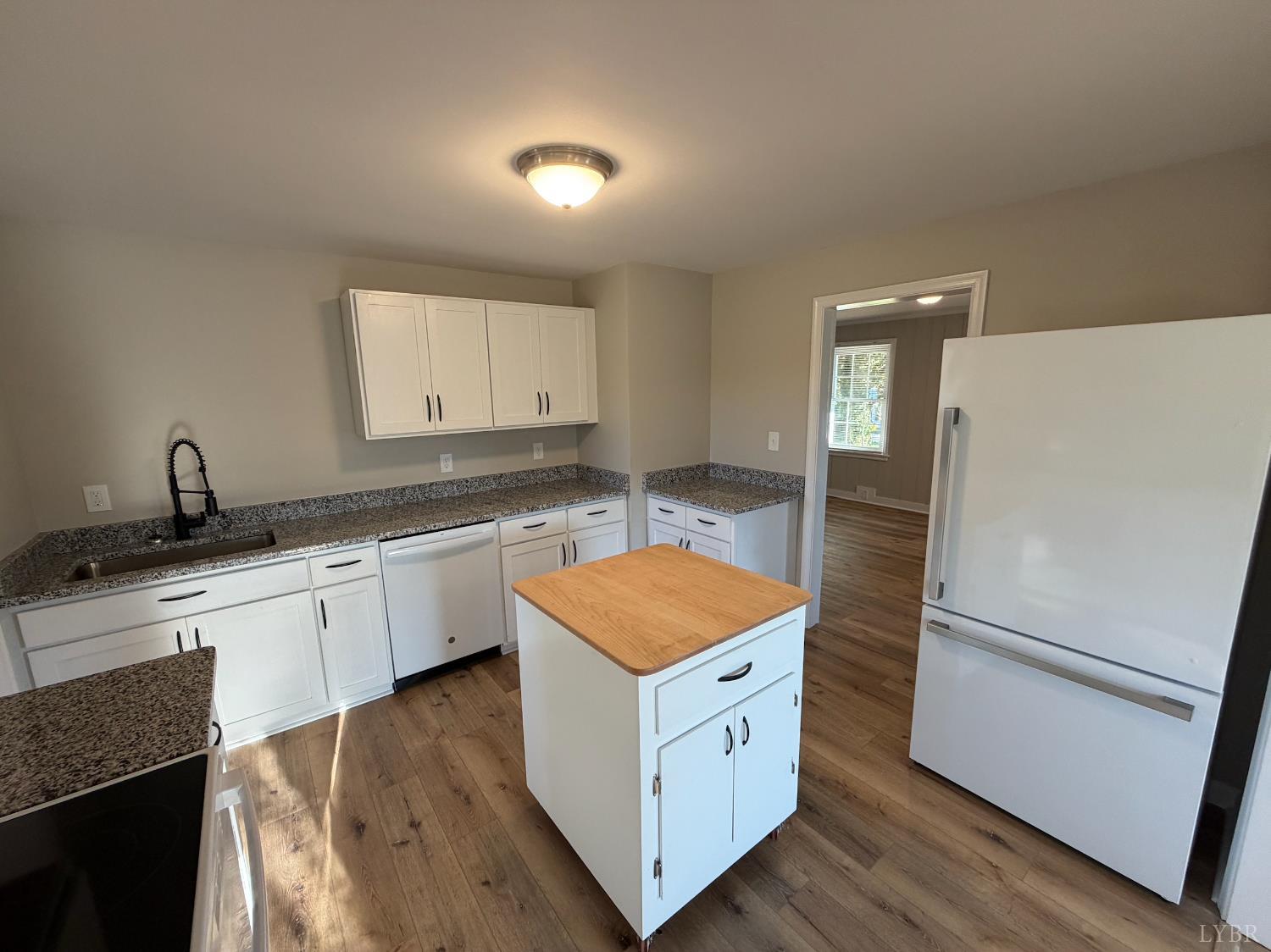 127 Campbell Street Madison Heights, VA 24572 - Photo 5 of 28 a kitchen with granite countertop white cabinets and white appliances
