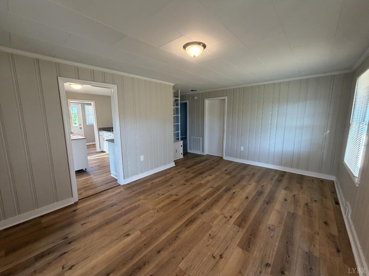 127 Campbell Street Madison Heights, VA 24572 - Photo 7 of 28 wooden floor in an empty room with a window