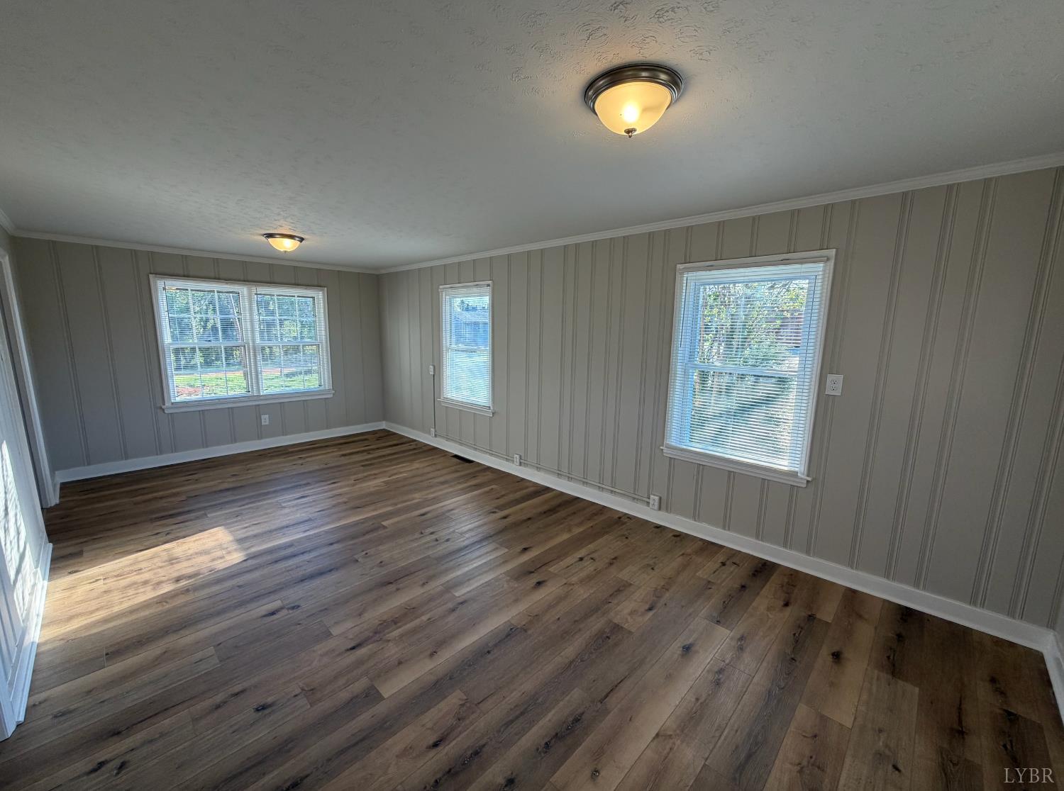 127 Campbell Street Madison Heights, VA 24572 - Photo 9 of 28 a view of an empty room with wooden floor and a window