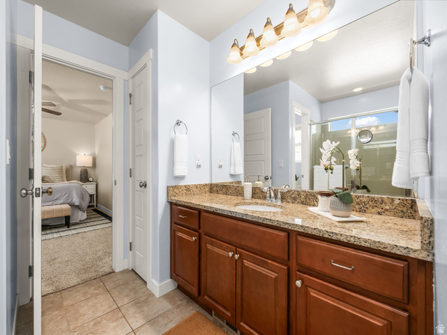 834 West 1050th Street South Springville, UT 84663 - Photo 14 of 26 Bathroom featuring a vanity with a granite countertop, wood cabinetry, and tile flooring