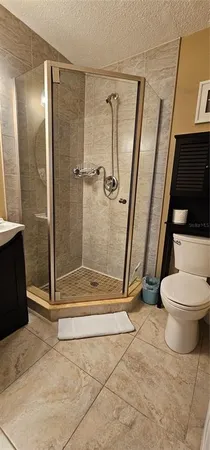 a bathroom with a toilet and a shower