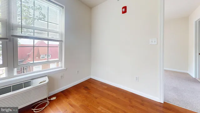 a view of a livingroom with wooden floor and windows