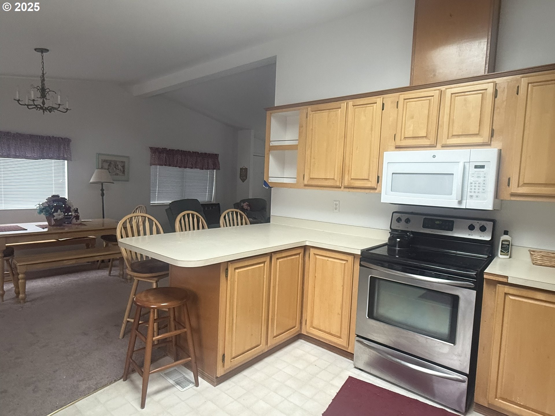 1601 Rhododendron Drive, Unit 654 Florence, OR 97439 - Photo 11 of 24 a kitchen with a stove a sink and a microwave