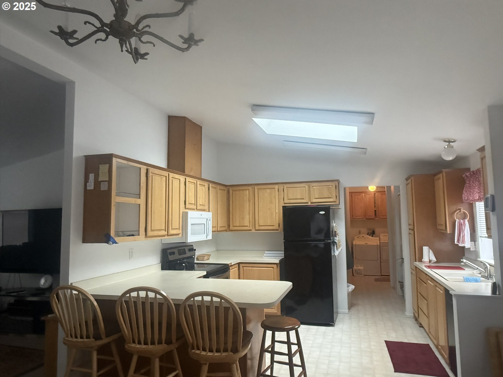 1601 Rhododendron Drive, Unit 654 Florence, OR 97439 - Photo 13 of 24 a kitchen with a refrigerator and a stove top oven