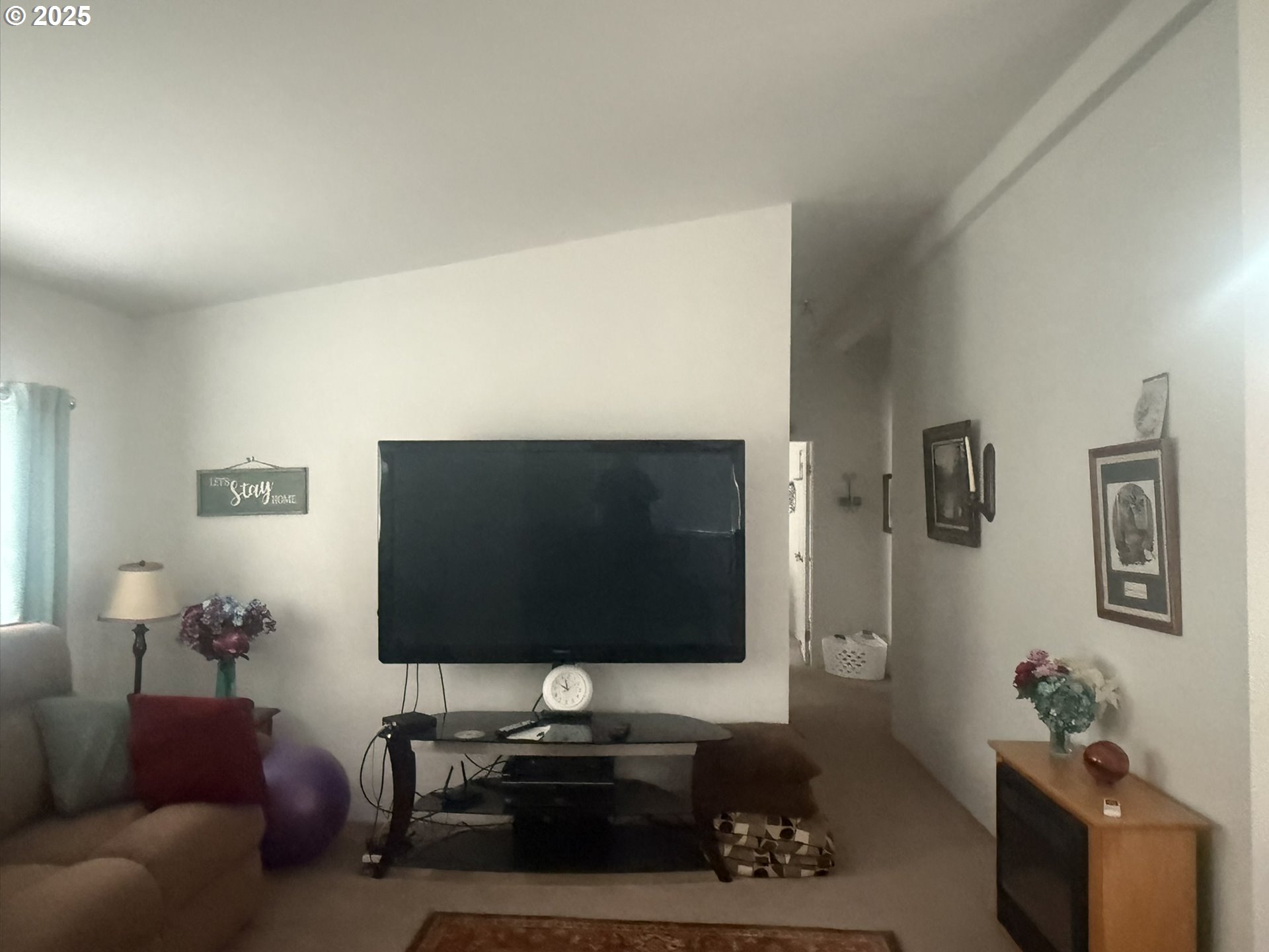 1601 Rhododendron Drive, Unit 654 Florence, OR 97439 - Photo 14 of 24 a living room with furniture and a flat screen tv