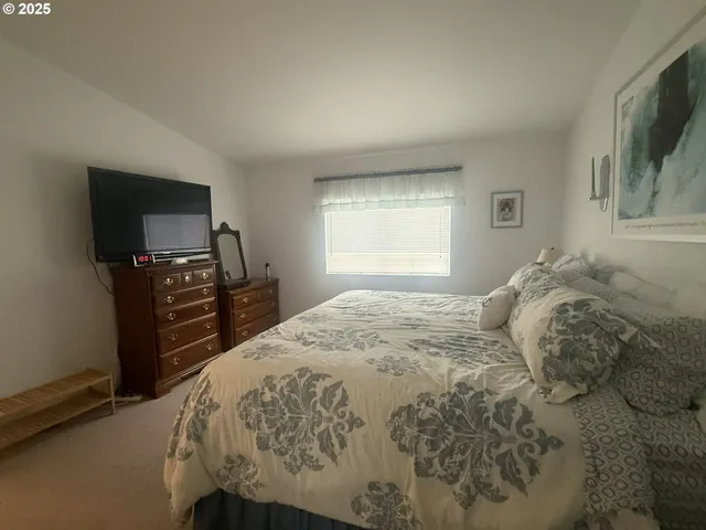 a bedroom with a bed and flat screen tv