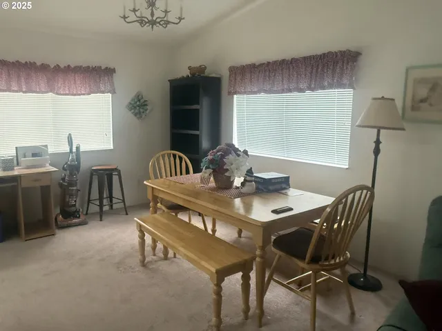 a dining room with furniture and window