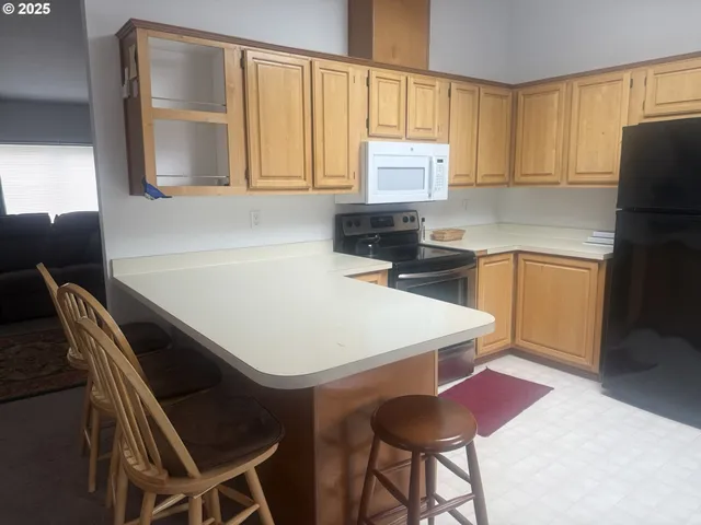 a kitchen with a table chairs sink and cabinets