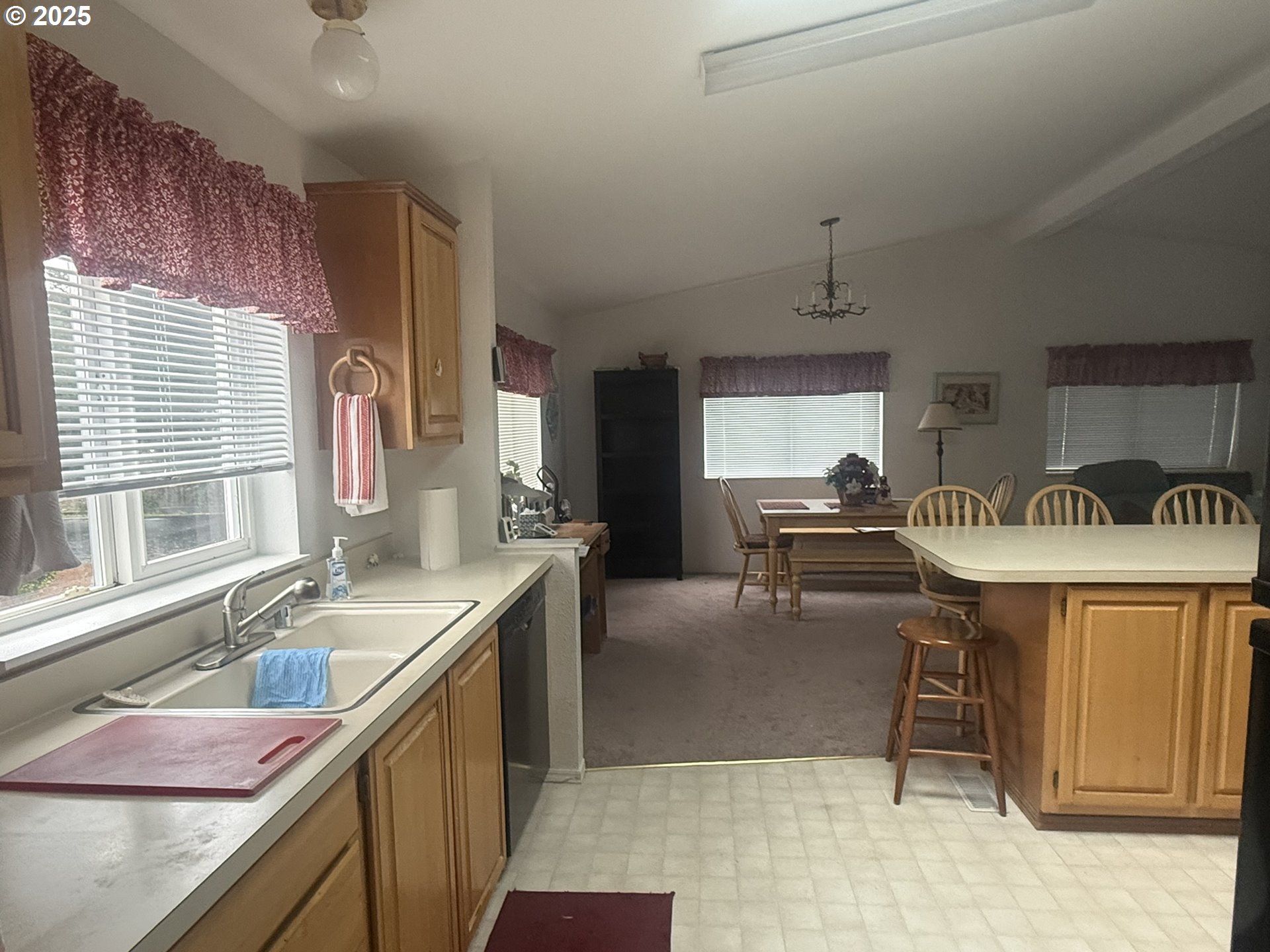 1601 Rhododendron Drive, Unit 654 Florence, OR 97439 - Photo 10 of 24 a kitchen with a sink and chairs