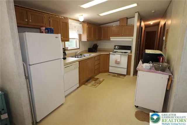 a kitchen with refrigerator a sink and cabinets
