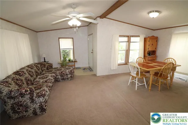 a living room with furniture a window and a chandelier