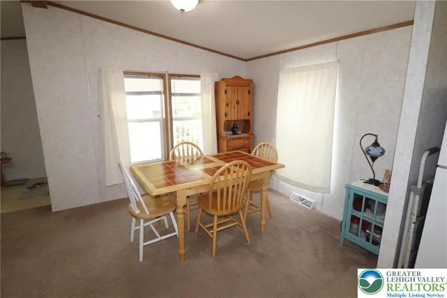 a view of a dining room with furniture and a window