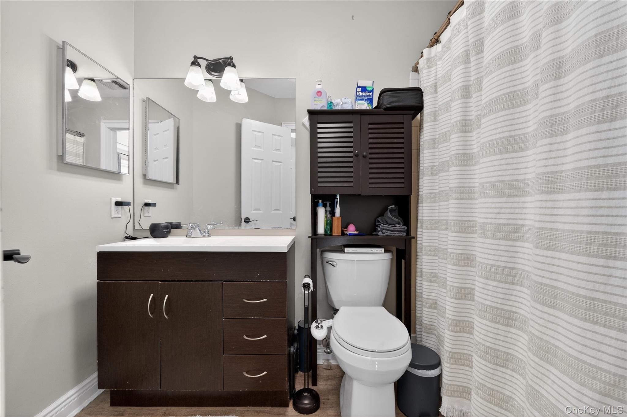 171 Melanie Way Commack, NY 11725 - Photo 11 of 29 Full bath with a shower with shower curtain, vanity, and light wood-style flooring