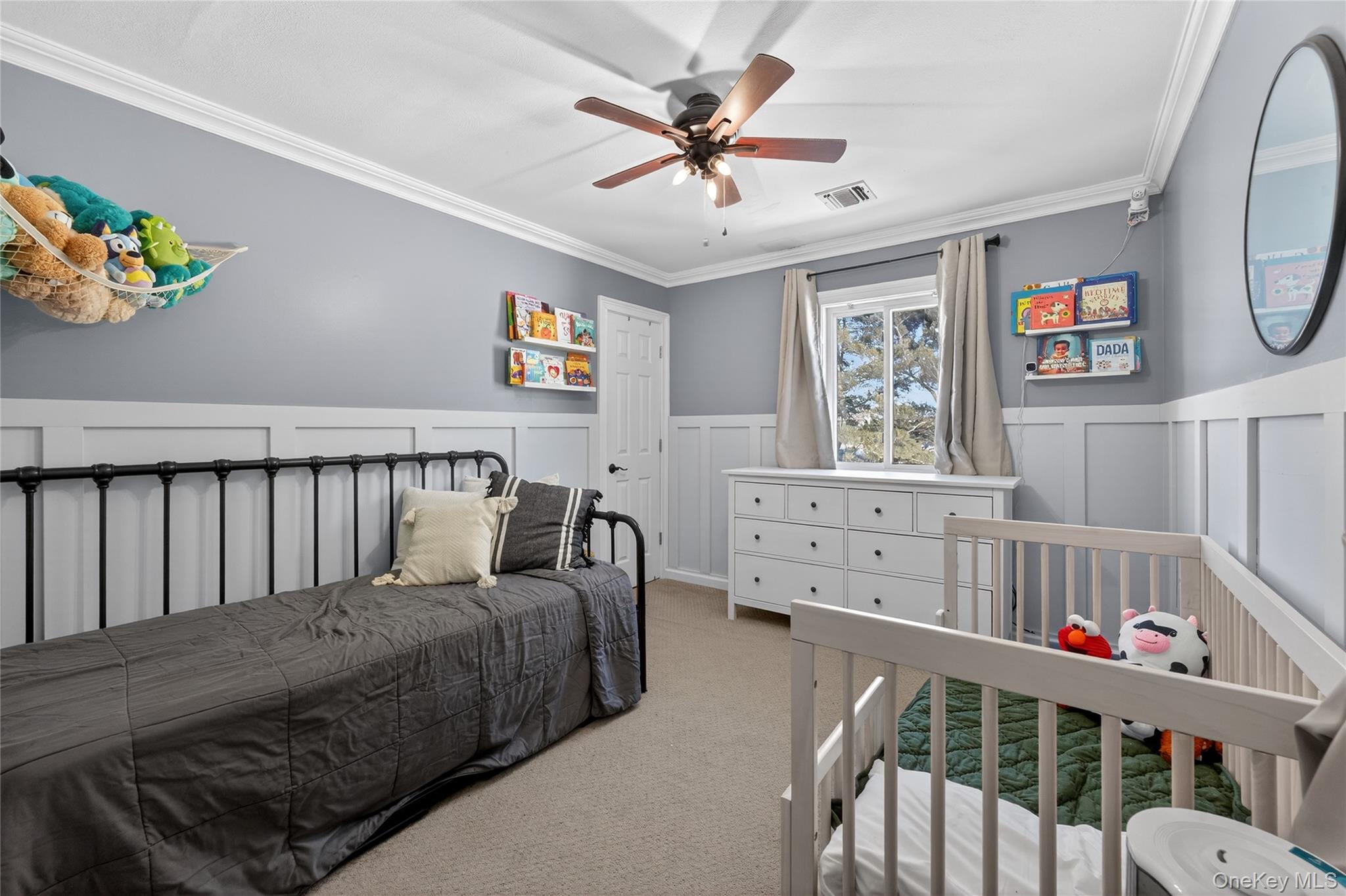 171 Melanie Way Commack, NY 11725 - Photo 12 of 29 Bedroom with crown molding, light colored carpet, a wainscoted wall, a ceiling fan, and a decorative wall