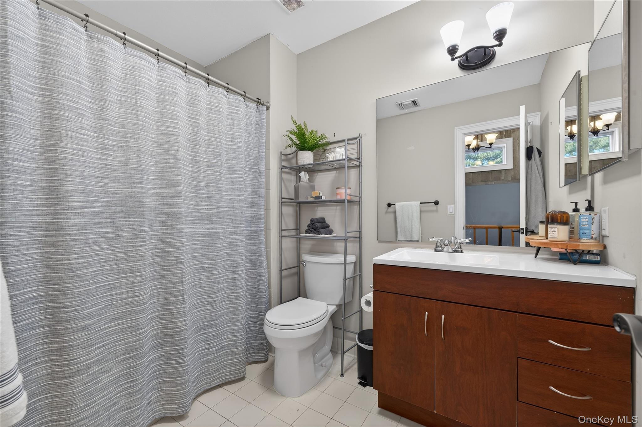 171 Melanie Way Commack, NY 11725 - Photo 13 of 29 Bathroom with a shower with curtain, vanity, and light tile patterned flooring