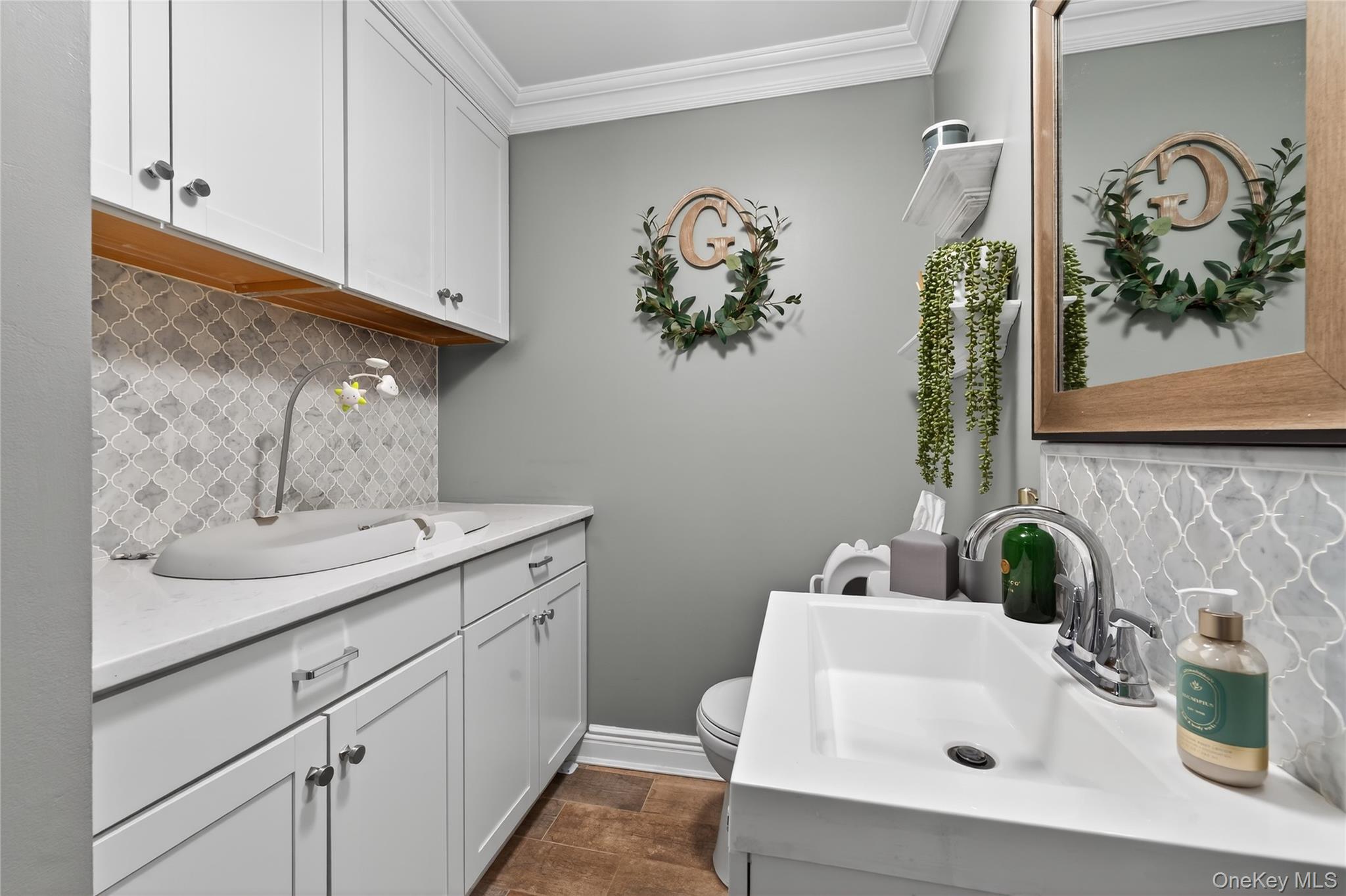 171 Melanie Way Commack, NY 11725 - Photo 14 of 29 Bathroom featuring backsplash, crown molding, and vanity