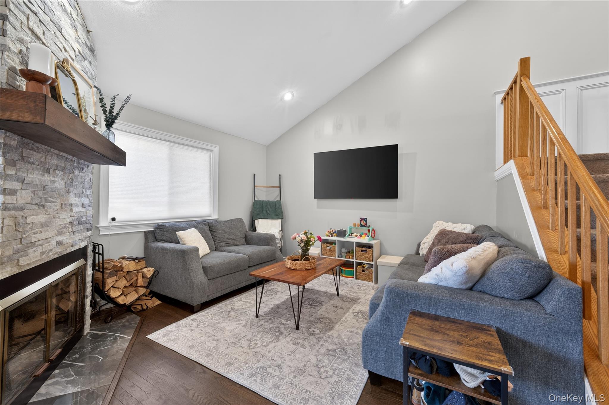 171 Melanie Way Commack, NY 11725 - Photo 4 of 29 Living room with a fireplace, vaulted ceiling, dark wood-type flooring, and recessed lighting
