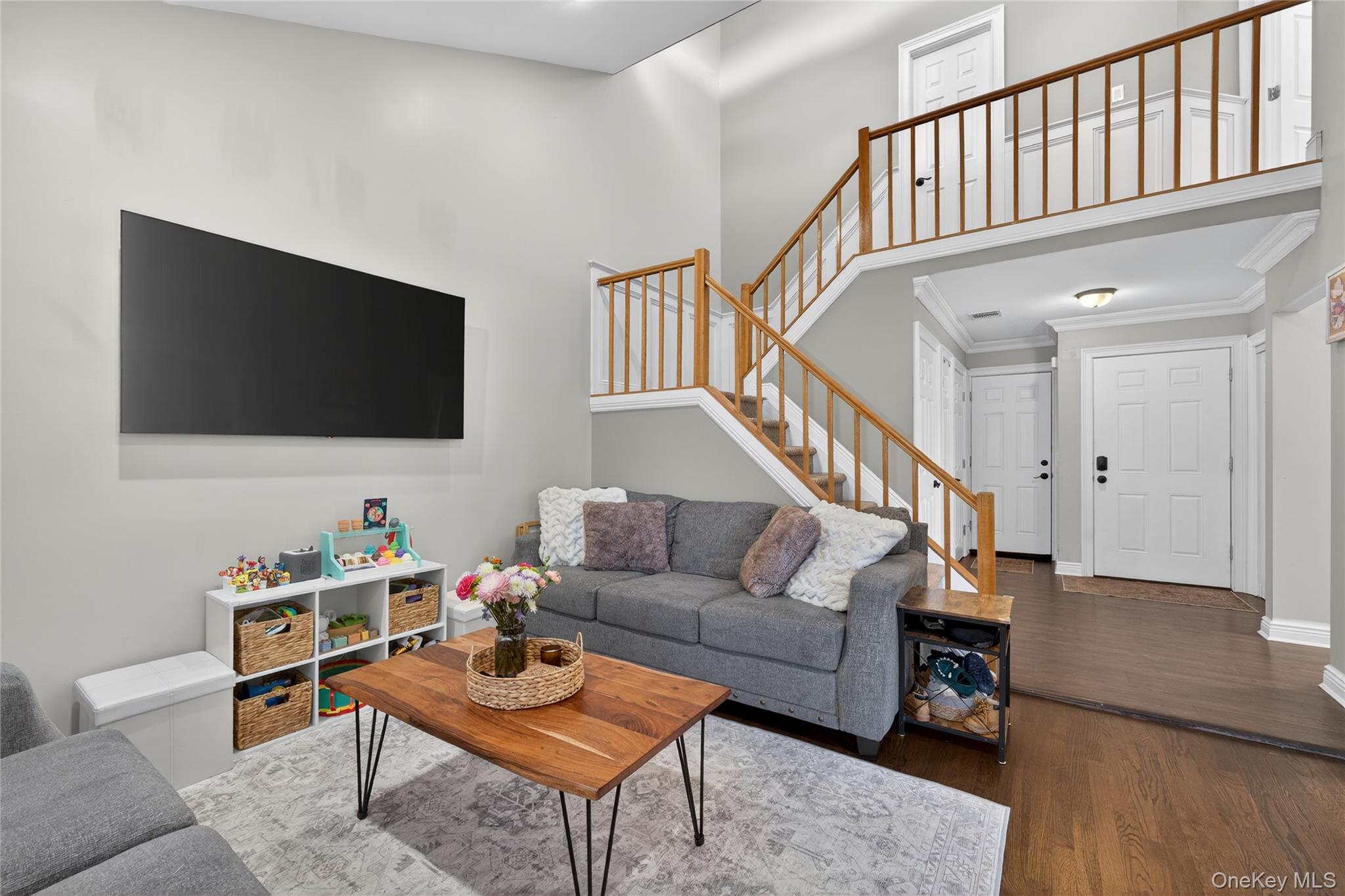 171 Melanie Way Commack, NY 11725 - Photo 6 of 29 Living area featuring a high ceiling, wood finished floors, and crown molding