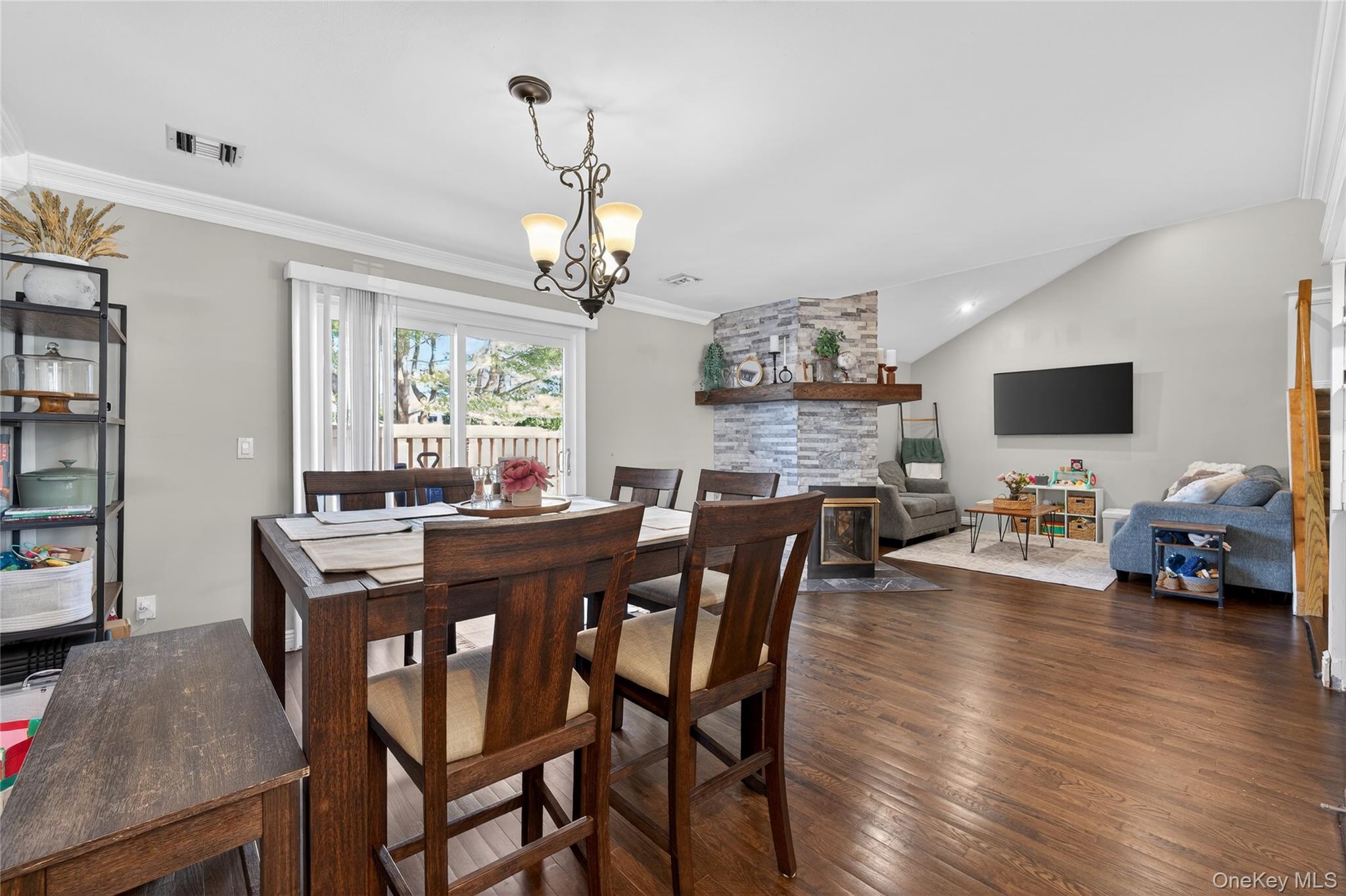 171 Melanie Way Commack, NY 11725 - Photo 9 of 29 Dining room featuring crown molding, dark wood finished floors, suspended lighting, and vaulted ceiling