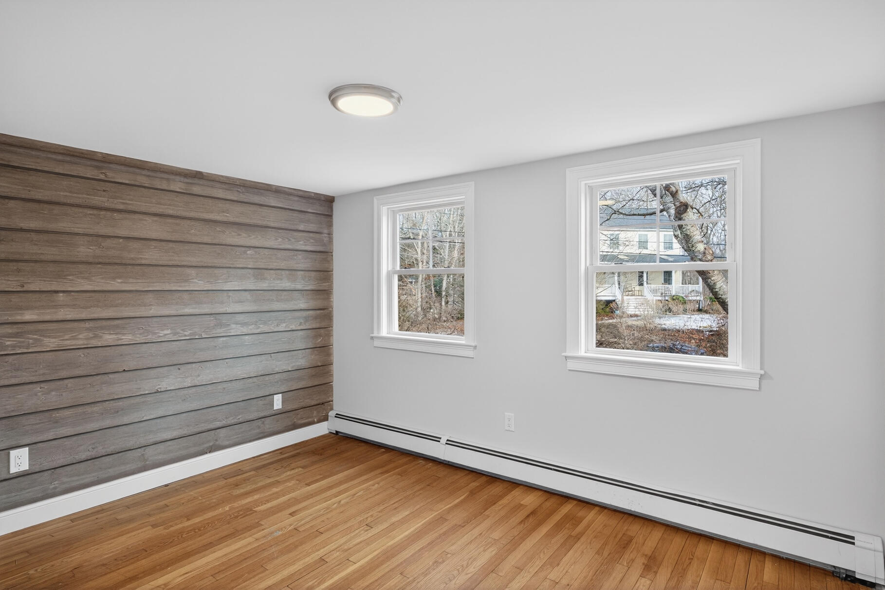 141 Braeside Road Falmouth, MA 02540 - Photo 10 of 47 a view of an empty room with a window and wooden floor