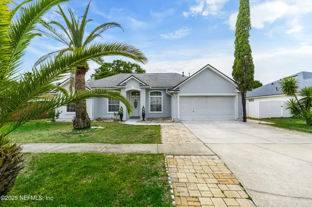 a front view of a house with a garden and entryway