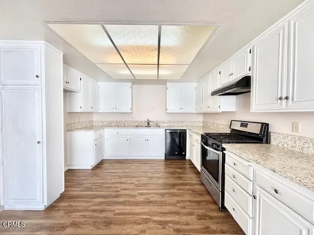 a kitchen with stainless steel appliances granite countertop a stove and a sink