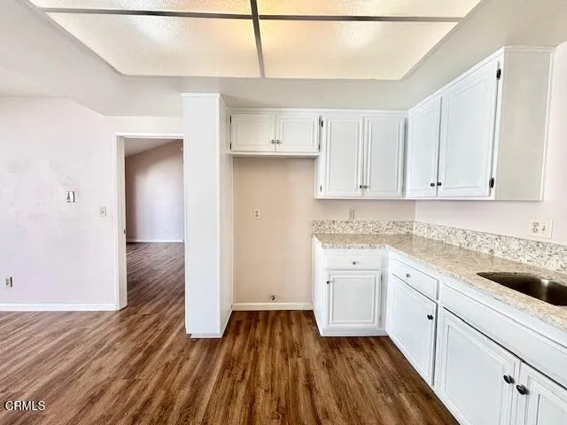 a kitchen with a sink window and cabinets