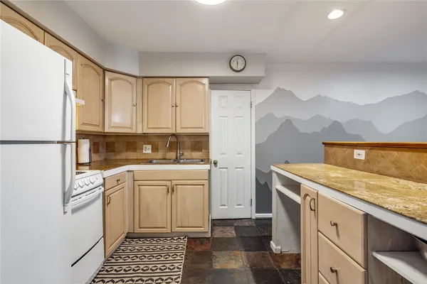 a kitchen with a stove a sink and a refrigerator