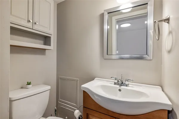 a bathroom with a sink a toilet and vanity