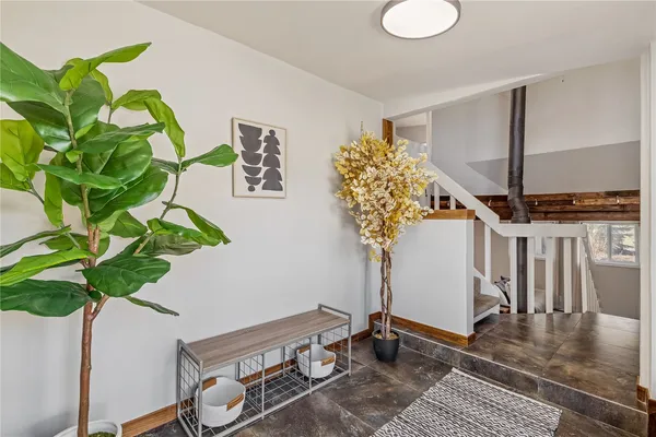 a view of living room with furniture and a potted plant