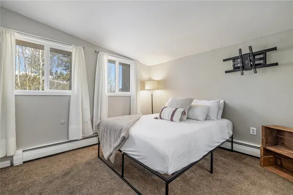 a bedroom with a bed and window