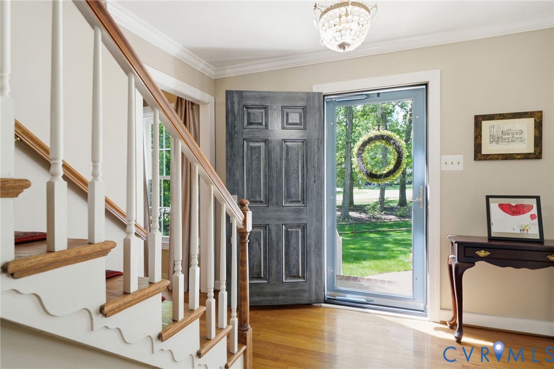 2101 Castlebridge Road Midlothian, VA 23113 - Photo 4 of 37 a view of an entryway with wooden floor and windows
