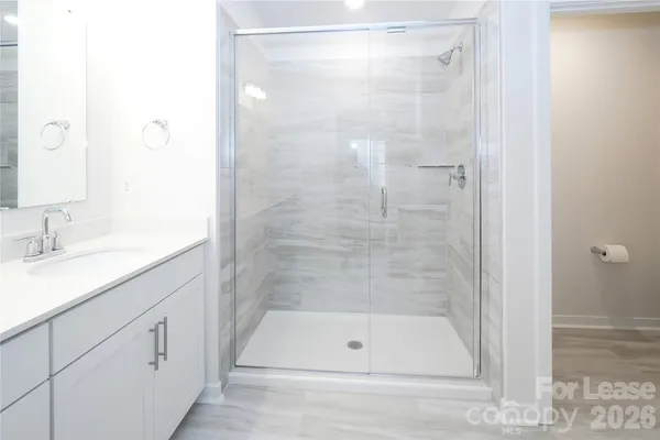a bathroom with a shower and a sink