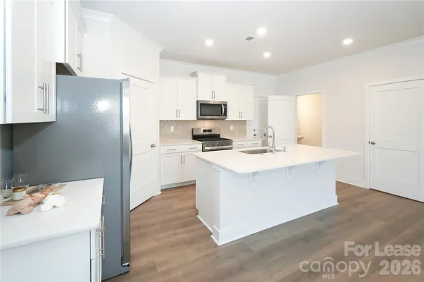 a kitchen with a sink stove and refrigerator