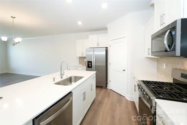 a kitchen with a sink stove and refrigerator