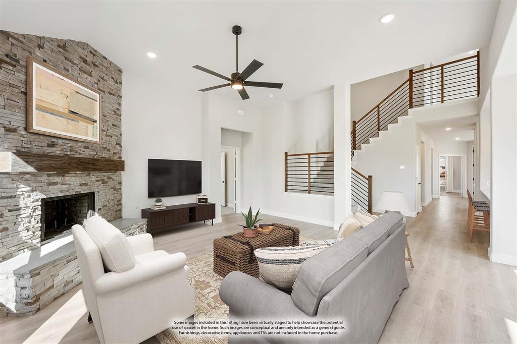 913 Firewood Way Anna, TX 75409 - Photo 18 of 40 a living room with furniture a fireplace and a flat screen tv