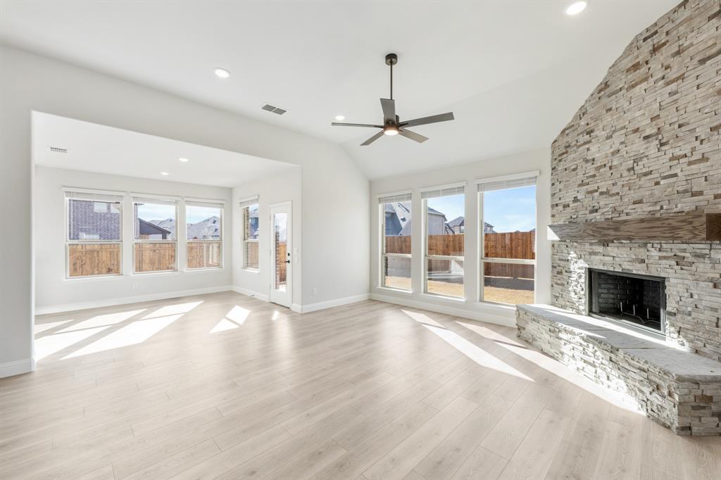 913 Firewood Way Anna, TX 75409 - Photo 19 of 40 a view of an empty room with wooden floor fireplace and a window